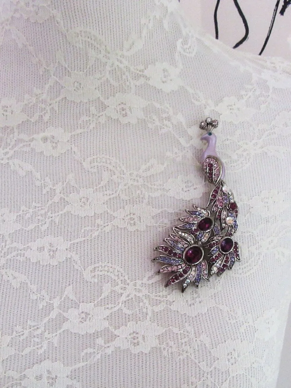 Peacock brooch with purple and aurora borealis rhinestones in silver setting
